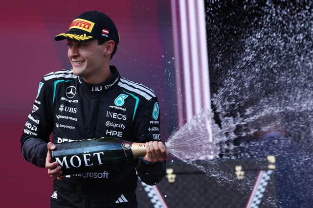 Race winner George Russell of Mercedes celebrates on the podium after the F1 Grand Prix of Austria. (Photo by Clive Rose/Getty Images)