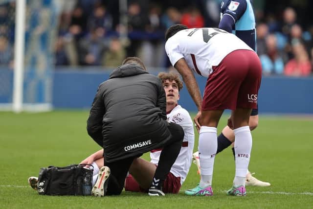 Tony Springett receives treatment after dislocating his finger