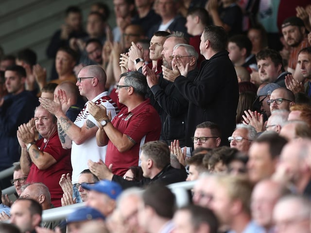 2019: Northampton Town fans observe a minutes applause in the 19th minute to honor the memory of Northampton fan Harry Dunn (19) who died in a motorbike accident on Tuesday August 27th during the Sky Bet League Two match between Northampton Town and Plymouth Argyle at PTS Academy Stadium on August 31, 2019 in Northampton, England. (Photo by Pete Norton/Getty Images)