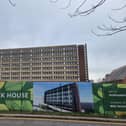 Adverts for The Clock House saying 'coming soon' are still up despite the plans being 'temporarily paused' by the council. Belgrave House lies behind the hoardings.