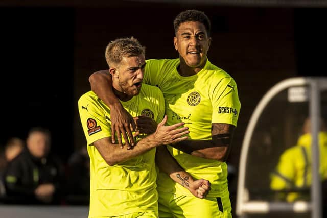 Callum Stead is congratulated by Glenn Walker after one of his goals in Brackley Town's 2-2 draw at Darlington last weekend. Picture by Glenn Alcock