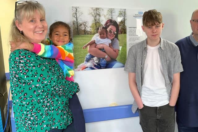 Sophie’s mum Debbie Marlow, Rennaisha Rogers, Toby Marlow, 15, and Brett Marlow with Sophie’s story board at NGH.