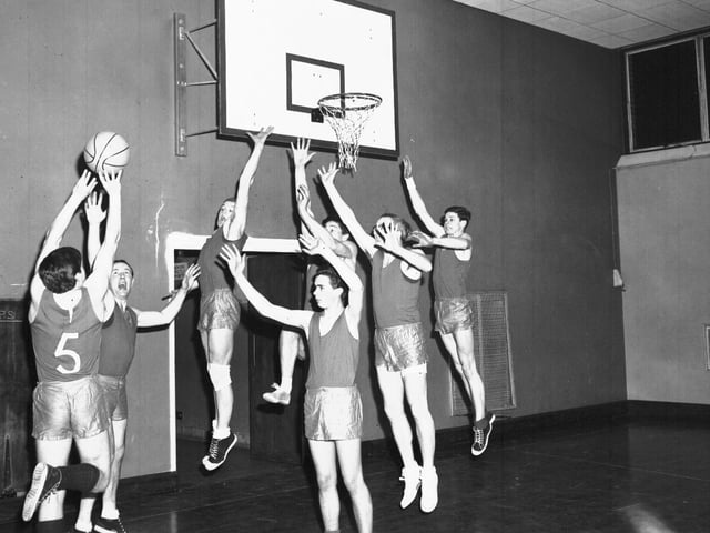 Boys playing basketball circa 1966