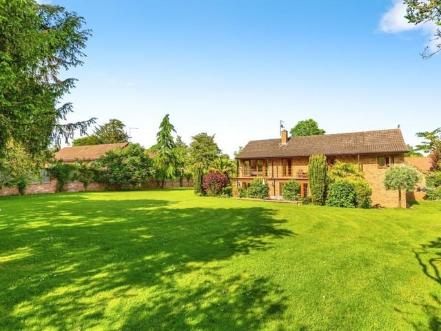 An enchanting back garden showcases the 0.45 acre space on offer with this deluxe property