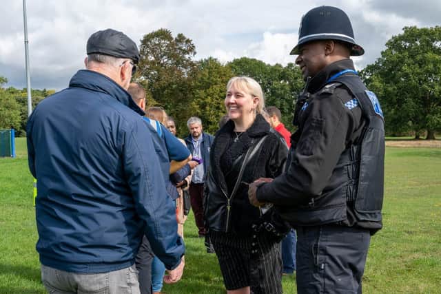 Sammie Wakefield (centre) of Eastfield Residents Association speaks with Sgt Rodney Williams (right)