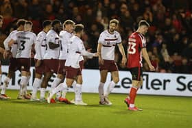 Jon Guthrie receives the plaudits after heading Cobblers ahead against Lincoln with his first goal of the season.