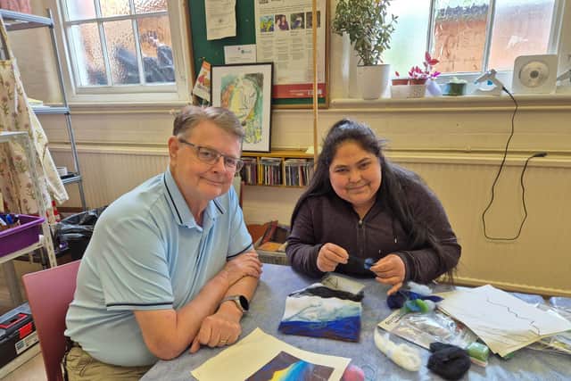 Stephen Parker from St Andrew's Healthcare sitting with patient Neelam