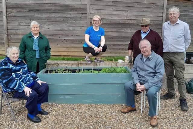Members of the Cando Cooperative Care community group enjoy the garden 