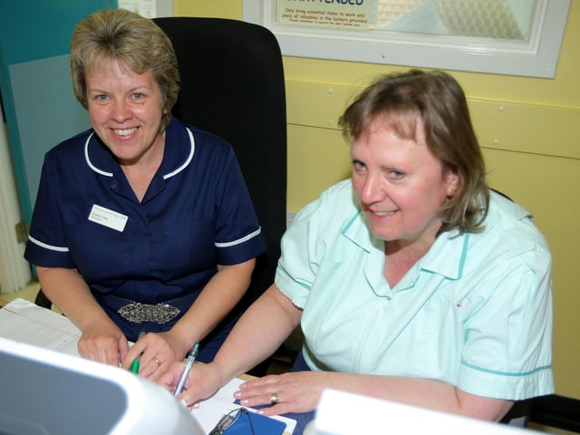 2009 - Elderly care at Northampton General Hospital. Pictured: Elaine Crisp, ward sister and Christine Liddle, ward receptionist, working at the reception desk.