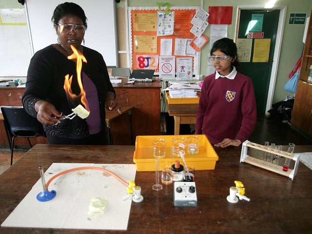 Alliyah Valentine, key stage three co-ordinator for science, doing an experiment watched by Tasleem Rehmatullah, 12, from Weston Favell School.