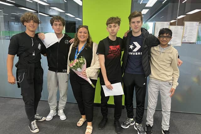 NIA students celebrate this year's GCSE results with head of year Danielle Rowley