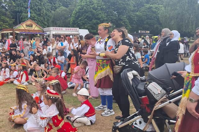 Groups of people enjoying the entertainment on stage.