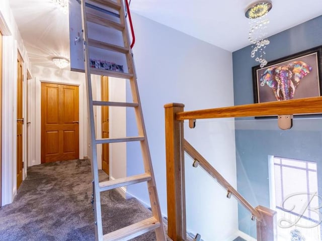 Up the stairs we go, to be greeted by this landing, which gives access to the four bedrooms. There is also a storage cupboard and a drop-down ladder that leads into the additional lounge in the roof space.