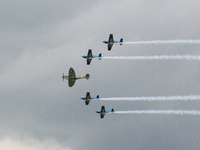 The Blades were joined by a Spitfire in 2010, as captured by a reader.