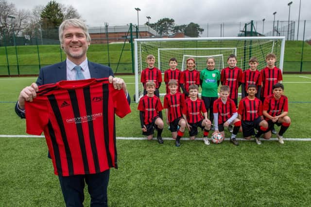 DWSM - 01032024-9 - Daniel from David Wilson Homes with Northampton School's Year 7 football team in