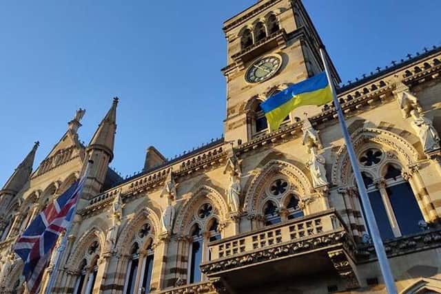 Ukraine and Union Flags fly side-by-side in front of Northampton's Guildhall.