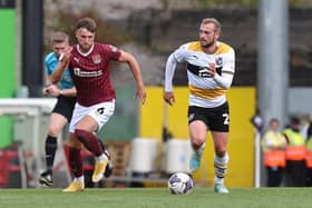 Sam Sherring chases down Port Vale striker James Wilson during the Cobblers' 1-0 defeat at Vale Park on Saturday (Pictures: Pete Norton/Getty Images)