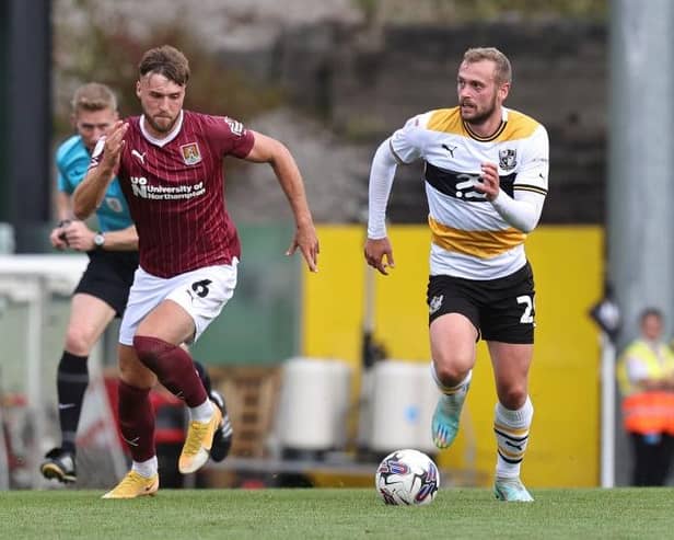 Sam Sherring chases down Port Vale striker James Wilson during the Cobblers' 1-0 defeat at Vale Park on Saturday (Pictures: Pete Norton/Getty Images)