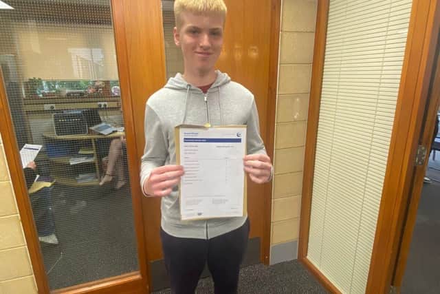 Alfie Clark celebrating his GCSE results at Brooke Weston Academy