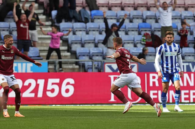 Sam Hoskins wheels away after scoring a superb free-kick during the Sky Bet League One match between Wigan Athletic and Northampton Town at DW Stadium on August 12, 2023 in Wigan, England. (Photo by Pete Norton/Getty Images)