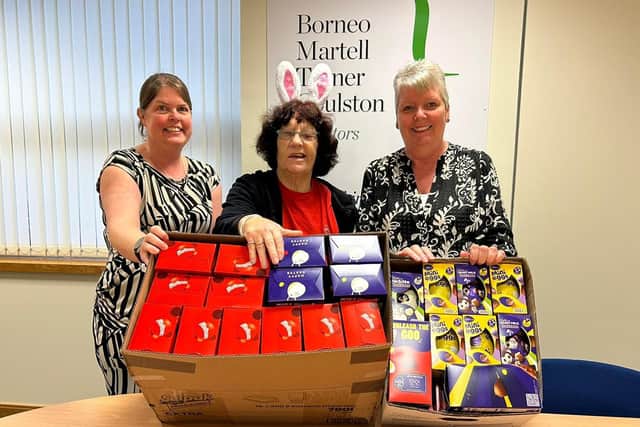 Borneo Martell in Kettering present Easter eggs to Jeanette Walsh (Mother Christmas)/UGC