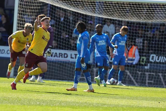 Sam Hoskins wheels away in delight after curling Cobblers into the lead against Peterborough