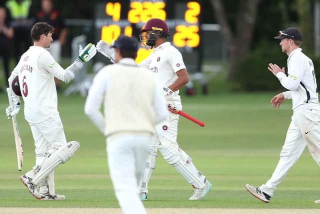Northants batter Sam Whiteman celebrates reaching his century against Middlesex with Emilio Gay (Picture; Warren Little/Getty Images)