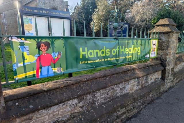 The Hands of Healing Banner design was supported by Kaye Sale, founder of Noggin Creative, who has been named a finalist in two categories at the SME Northamptonshire Business Awards 2026 — Business Person of the Year and Business Woman of the Year.