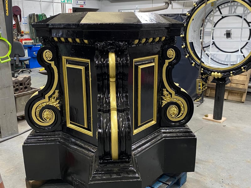 Applying a top coat of black gloss paint to all of the decorative metalwork, to the pillar, clock drum and the base.