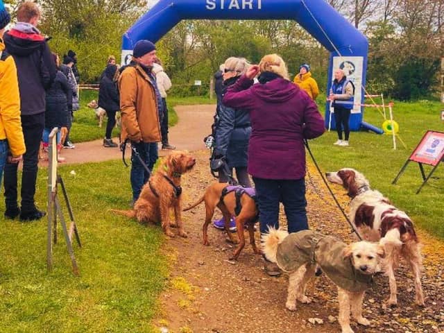 Dogs and their owners prepare to set off for Walkies for Cynthia at Brixworth Park