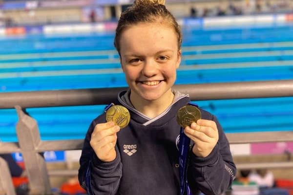 Maisie Summers Newton with the 2 Gold medals she won at the Para Swimming World Series event in Sheffield