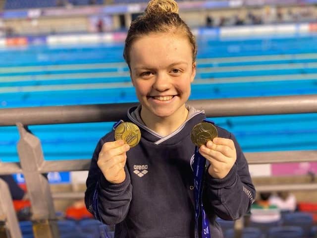 Maisie Summers Newton with the 2 Gold medals she won at the Para Swimming World Series event in Sheffield