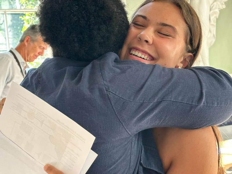 Ewa B celebrates with Dr Fiadzomor after achieving straight A's in History, Mathematics and Physics.