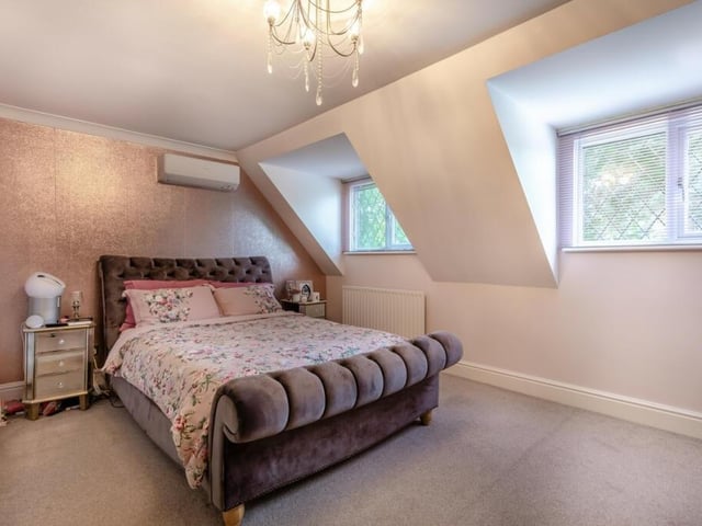 Another bedroom in the converted attic space is generously proportioned and also bursting with light