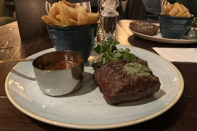 28 day-aged 7oz fillet steak served with rustic thick-cut chips, beef dripping pangrattato shallots, exotic mushrooms, parsley butter and beef dripping sauce.