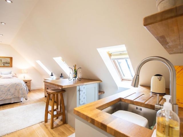 This modern family home is in a picturesque village and shares its boundary with a church.