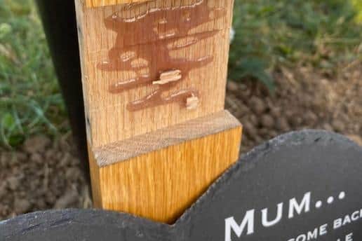The name plate of Mary Edwards was found scratched and lying in the dirt.