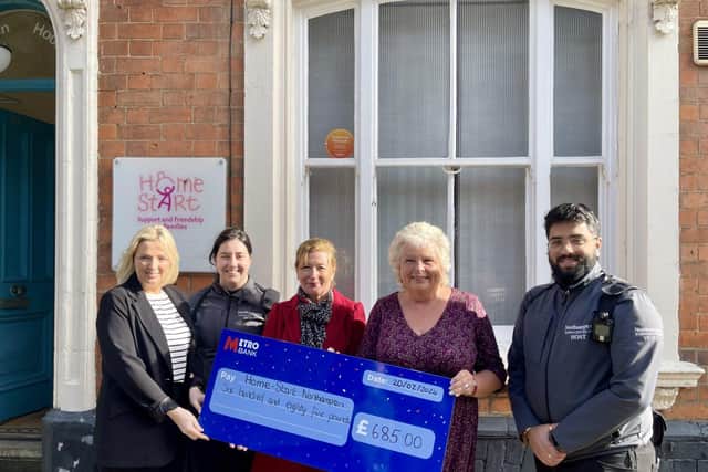 Zoe Reynolds and Julia Halliwell of Home-Start receiving the proceeds from BID co-chair Sali Brown