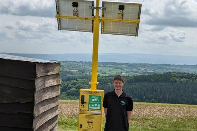 Mike Dowson, founder and MD of Turtle with an installed solar and wind powered defib cabinet 