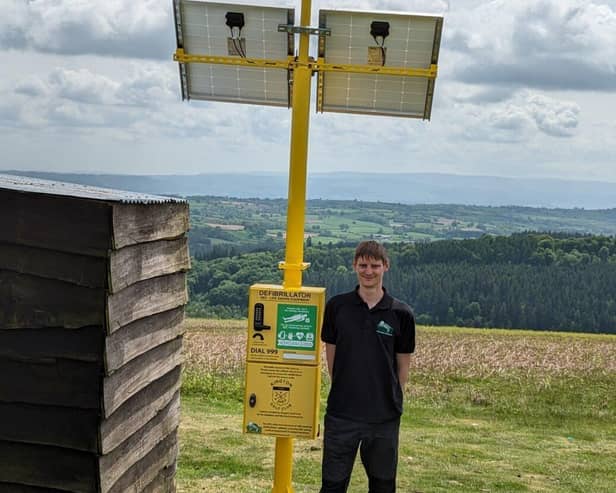 Mike Dowson, founder and MD of Turtle with an installed solar and wind powered defib cabinet 