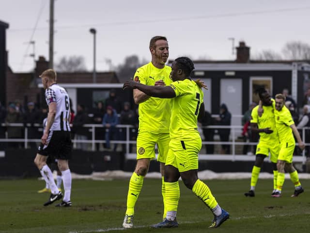 Cosmas Matwasa is congratulated by Adam Rooney after he gave Brackley Town the lead in their 1-1 draw at Spennymoor Town. Pictures by Glenn Alcock
