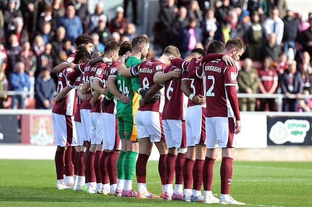 Northampton Town players observe a minutes silence during a Remembrance Day tribute prior to the Sky Bet League One match between Northampton Town and Mansfield Town at Sixfields on November 08, 2025 in Northampton, England. (Photo by Pete Norton/Getty Images)