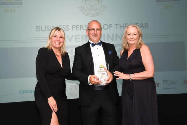 Luke Simmons collecting his silver Business Person of the Year award