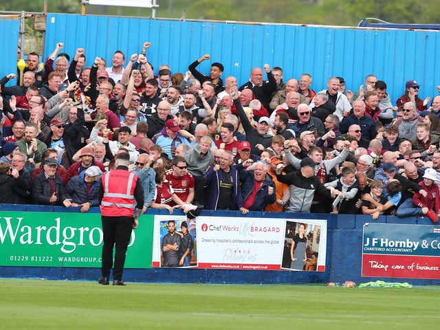 2022: Northampton Town fans celebrate after Sam Hoskins had scored his sides first goal during the Sky Bet League Two match between Barrow AFC and Northampton Town at Holker Street on May 07, 2022 in Barrow in Furness, England. (Photo by Pete Norton/Getty Images)
