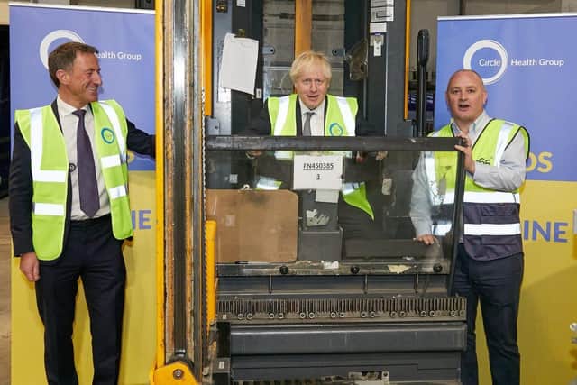 Boris sitting in a forklift truck to help load the supplies onto the lorry with Circle CEO Paolo Pieri.