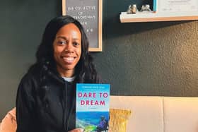 Lorraine Lewis holding her new book - Dare to Dream
