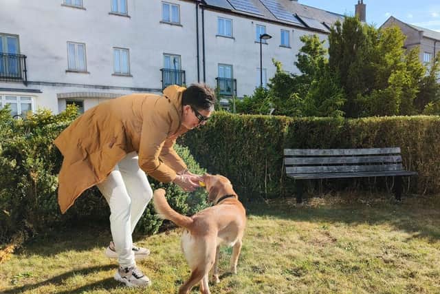 Volunteer Puppy Raiser Claire Reedman playing with guide dog puppy Sophie.