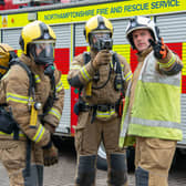 Firefighters discussing tactics at an incident in front of a fire engine