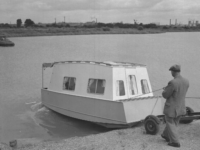 Man launching boat, perhaps at Billing Aquadrome