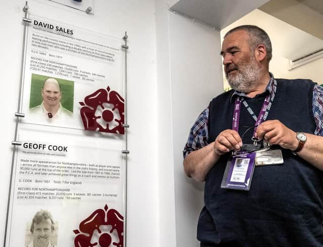 Author Andrew Radd pictured alongside the club's Hall Of Fame wall at the County Ground